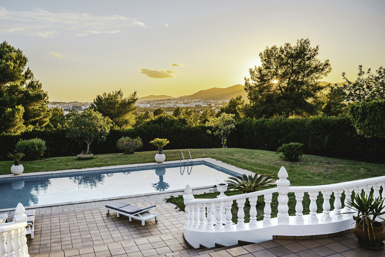 Terrace and pool at golden hour above the Sacramento foothills