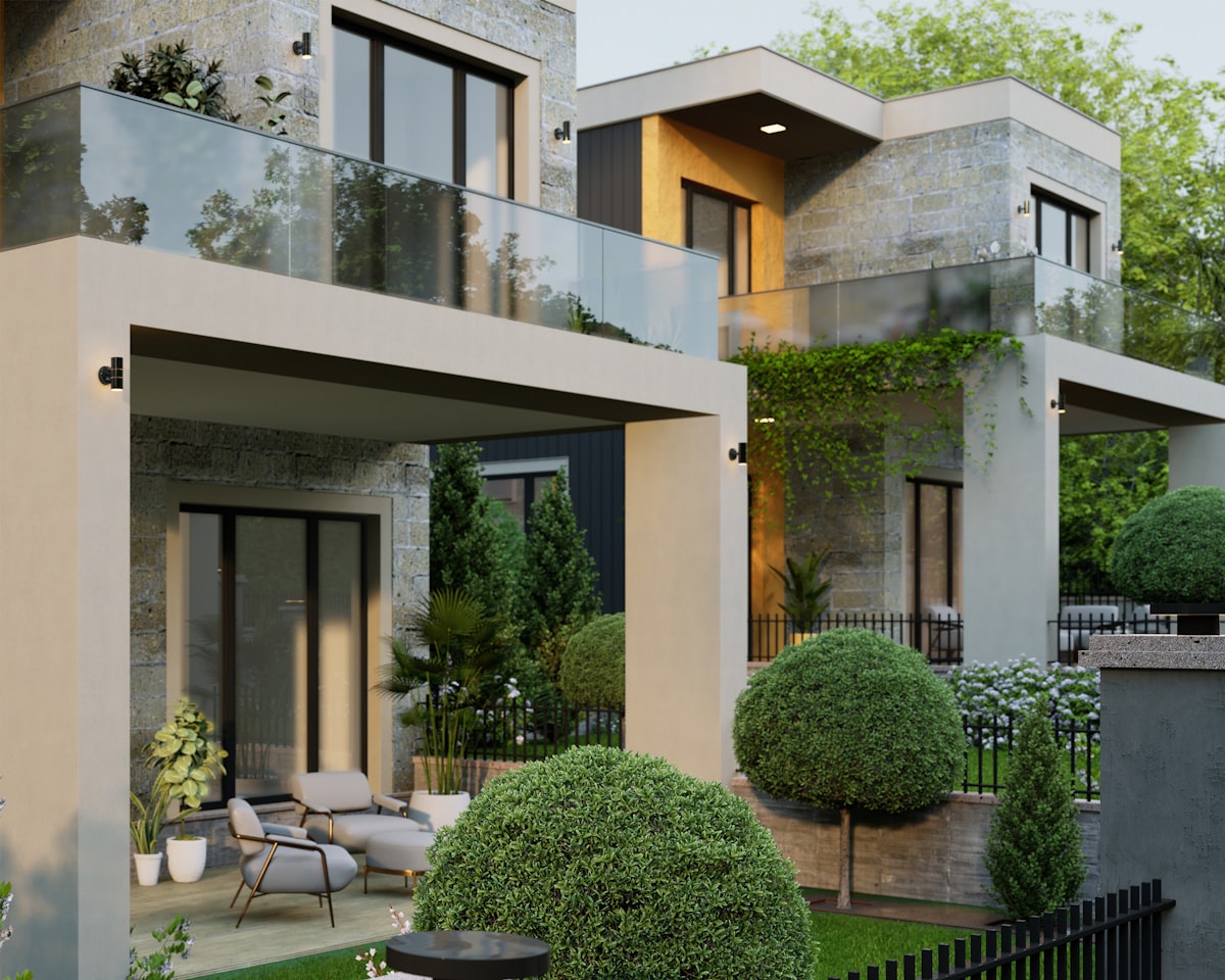 Stone and glass home surrounded by mature landscaping