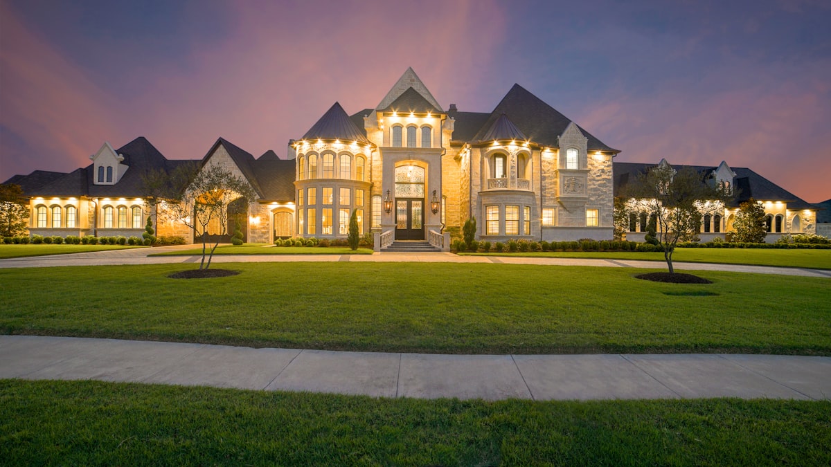 Estate home at twilight with warm interior light